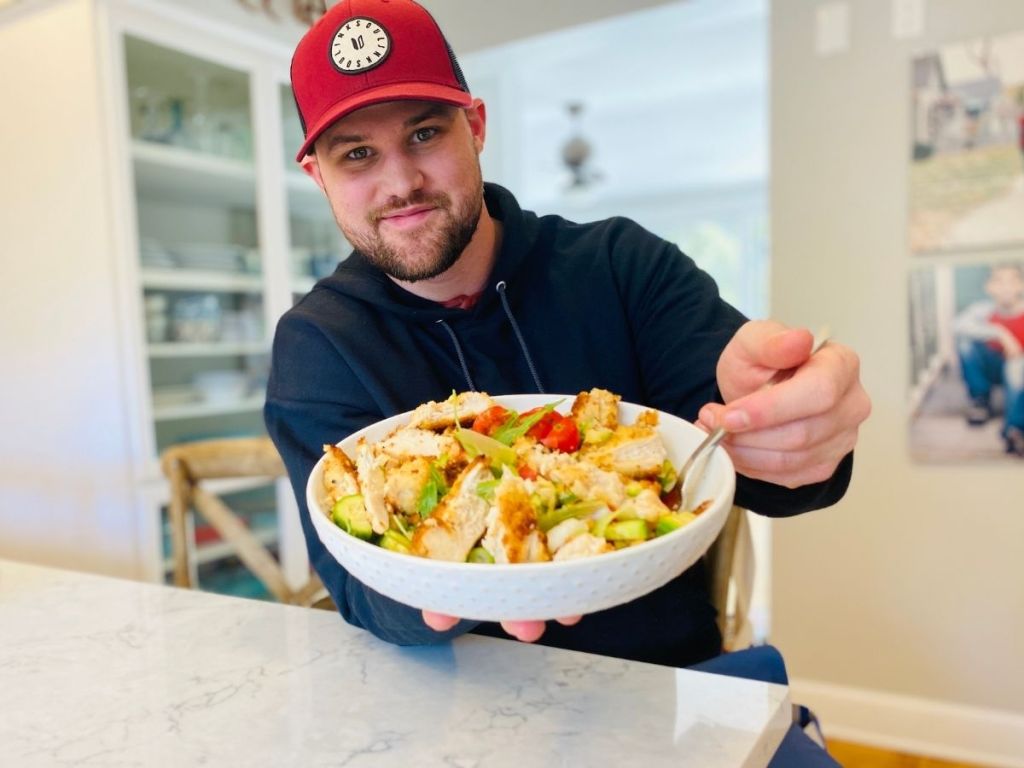 man holding a bowl of food