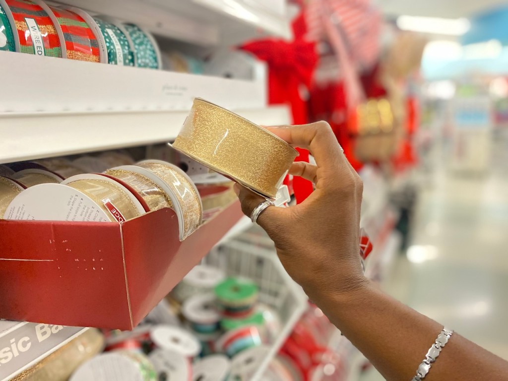 woman holding roll of ribbon from Joann