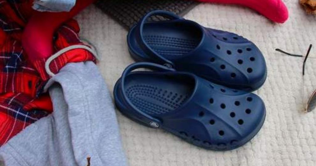 kids crocs baya clogs in navy on blanket