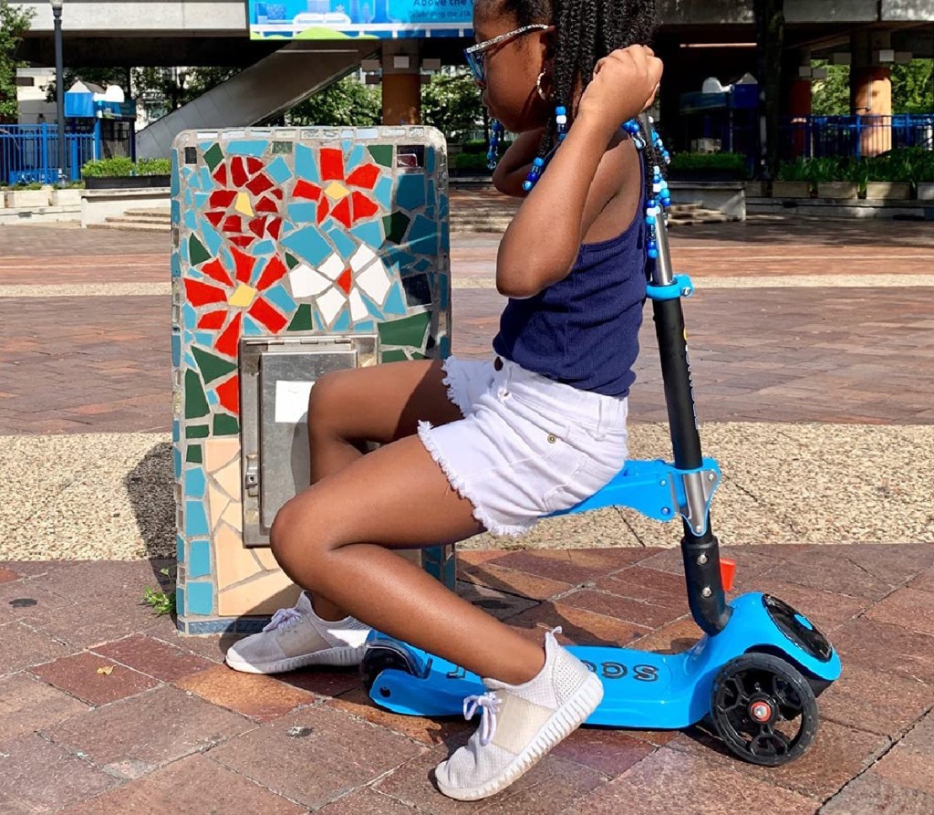 kid sitting on scooter