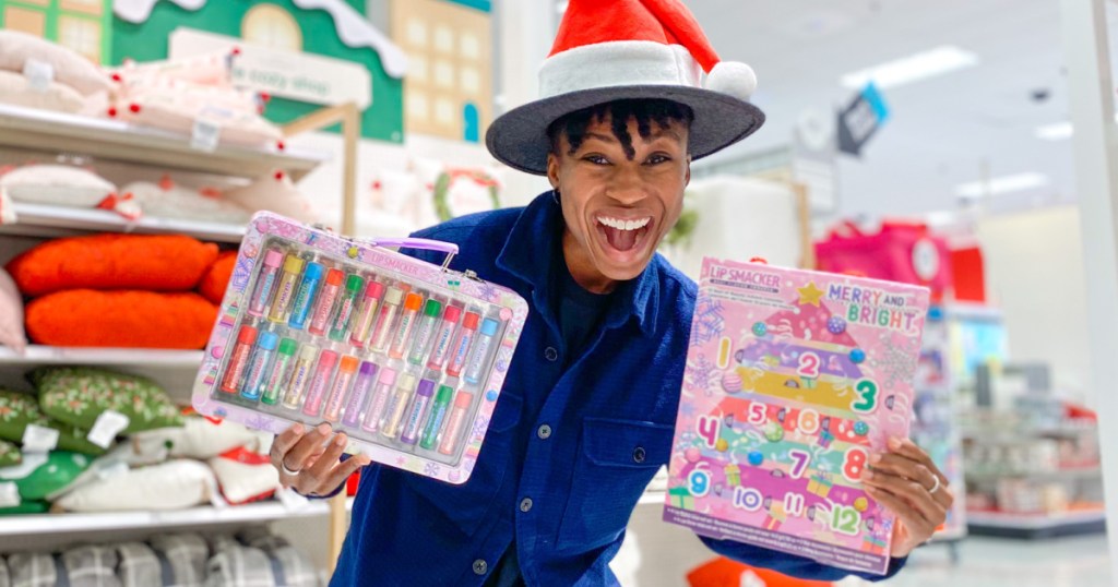 woman with big smile in store holding product boxes