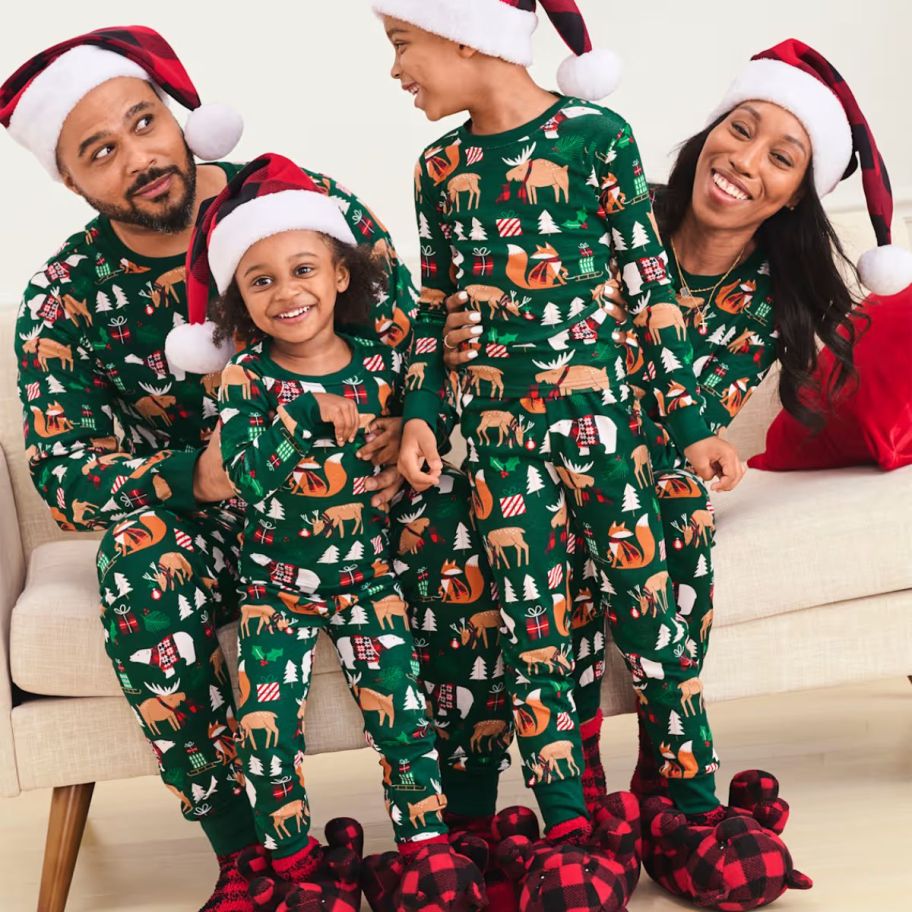 a family wearing matching christmas snug fit pajamas 