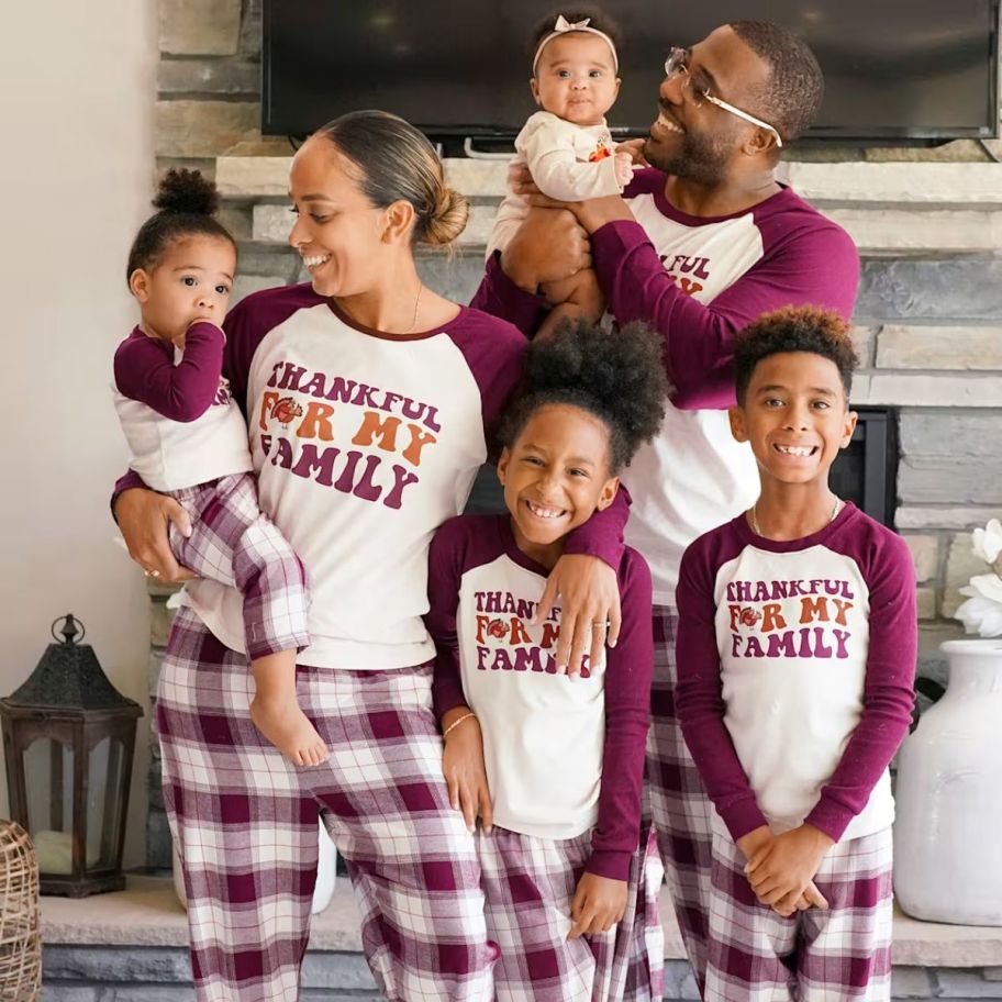 a family wearing matching thanksgiving pajamas 