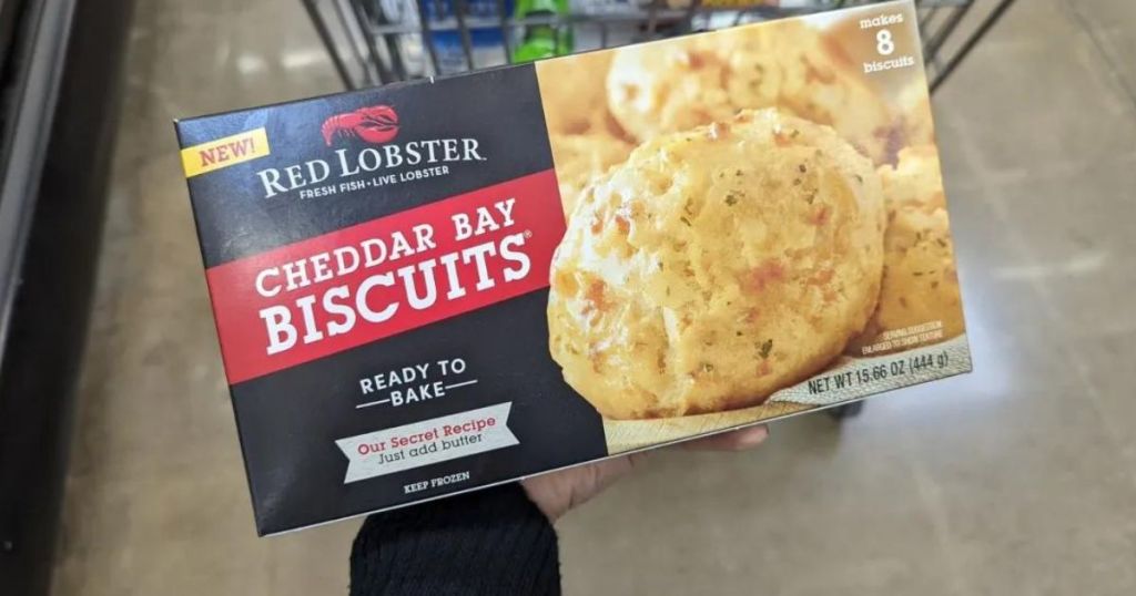 a hand holding a box of frozen biscuits