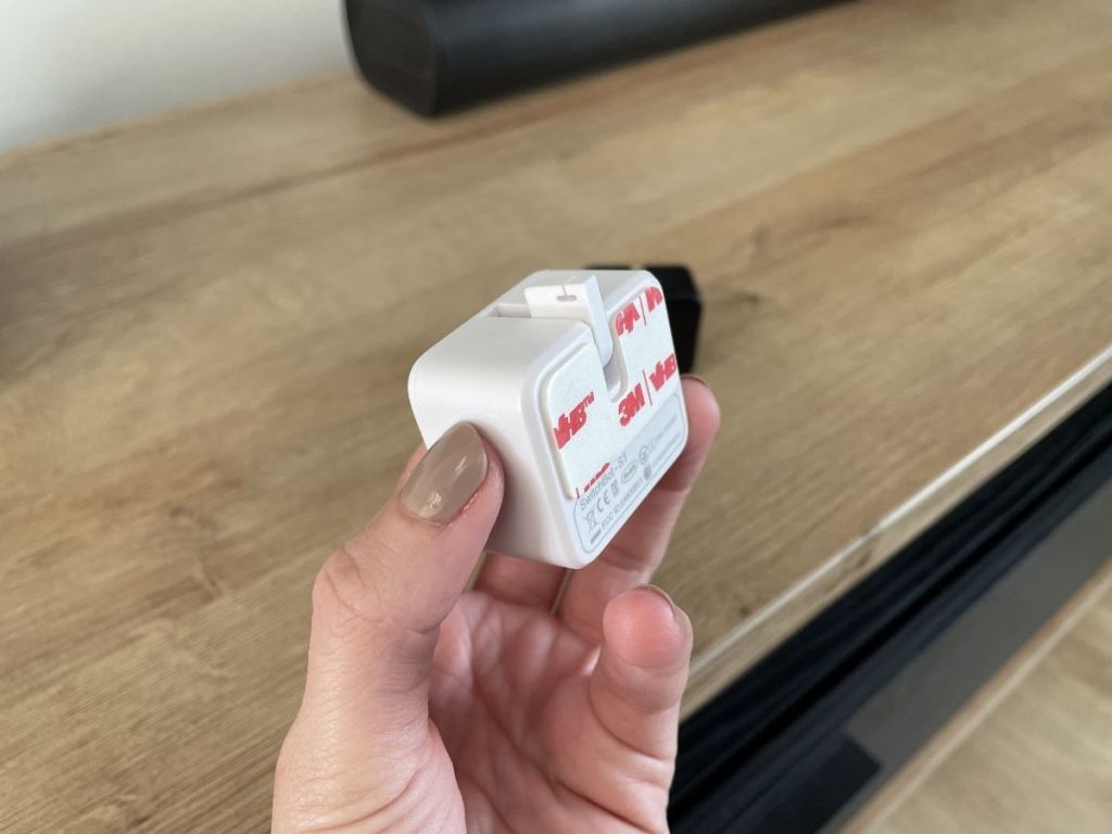 hand holding switchbot showing 3M sticker on back