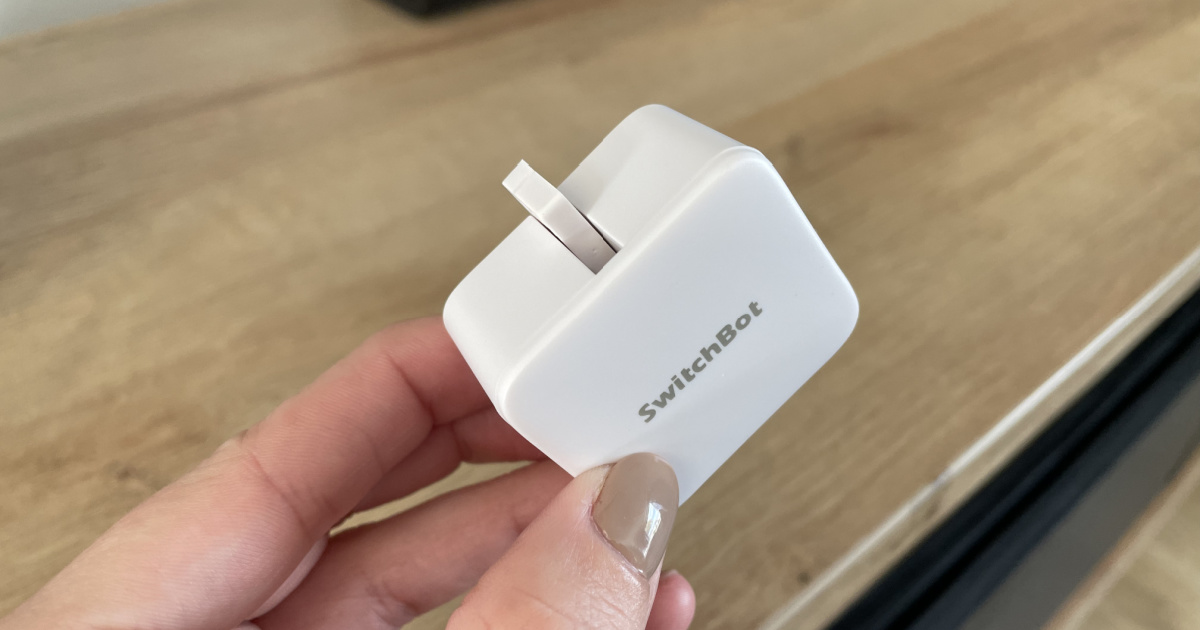 woman's hand holding smart switch