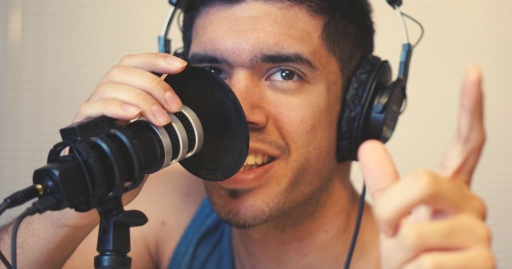 man wearing headphones speaking into microphone