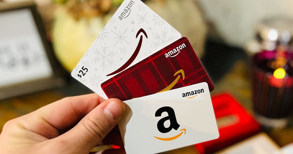 holding amazon holiday gift cards