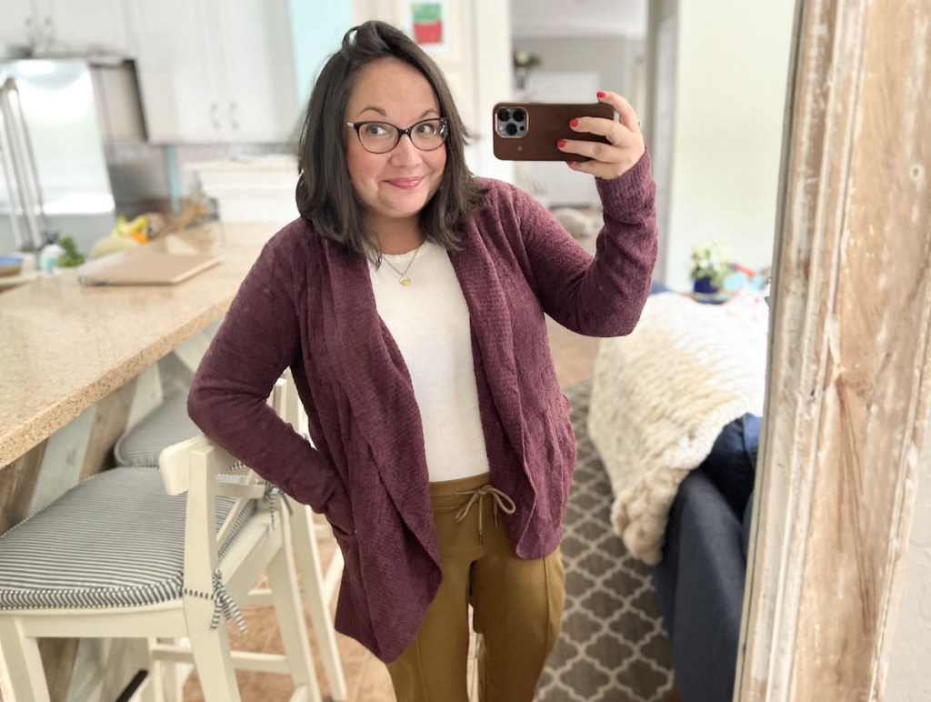 woman taking selfie in mirror wearing purple barefoot dreams cardigan