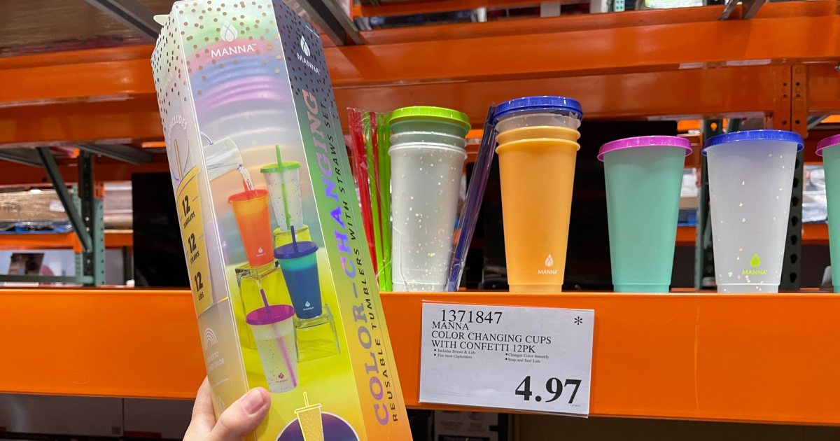 hand holding up a package of color changing cups in front of a store display