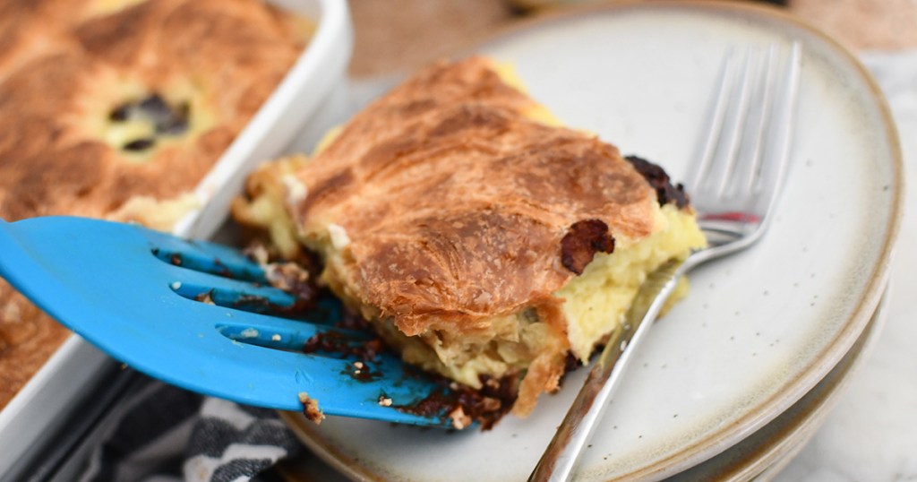 slice of croissant bread pudding being plated