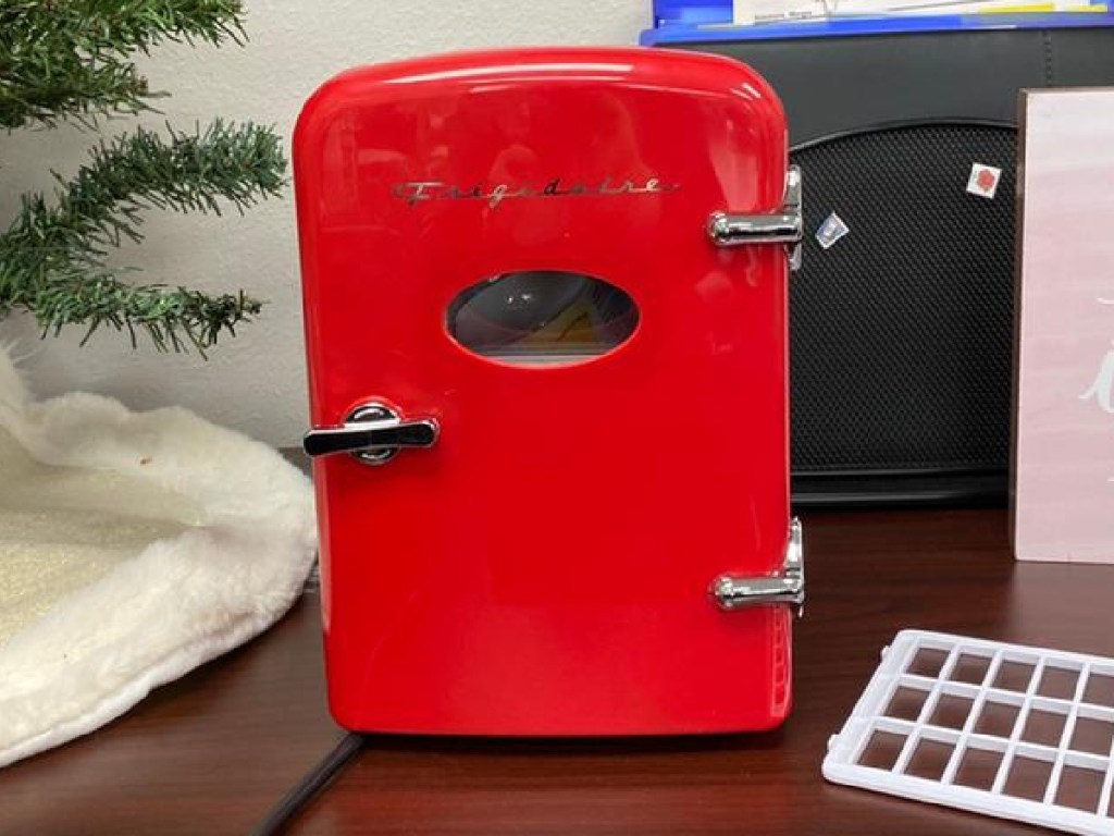 red mini fridge on desk