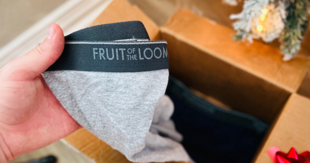hand removing pair of underwear from box