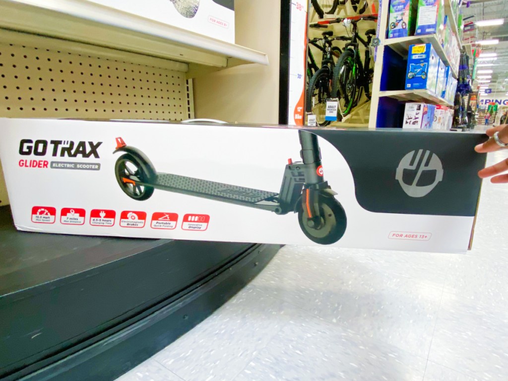 hand holding box with electric scooter in it