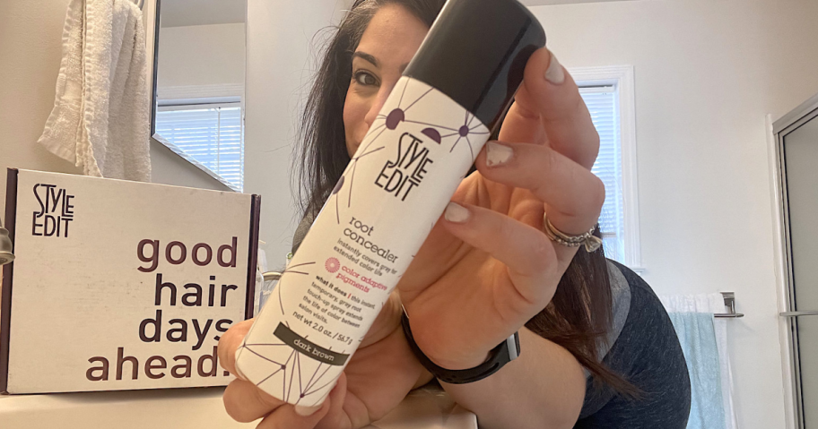 woman holding a bottle of Style Edit