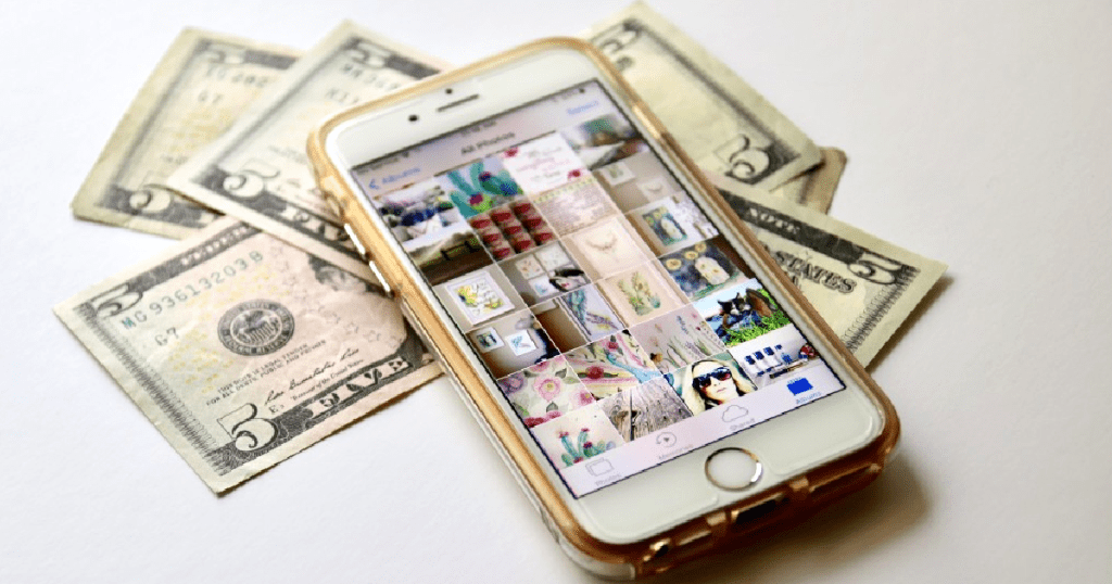 iPhone on counter with dollar bills 