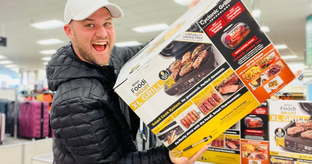 man holding up a large air fryer box