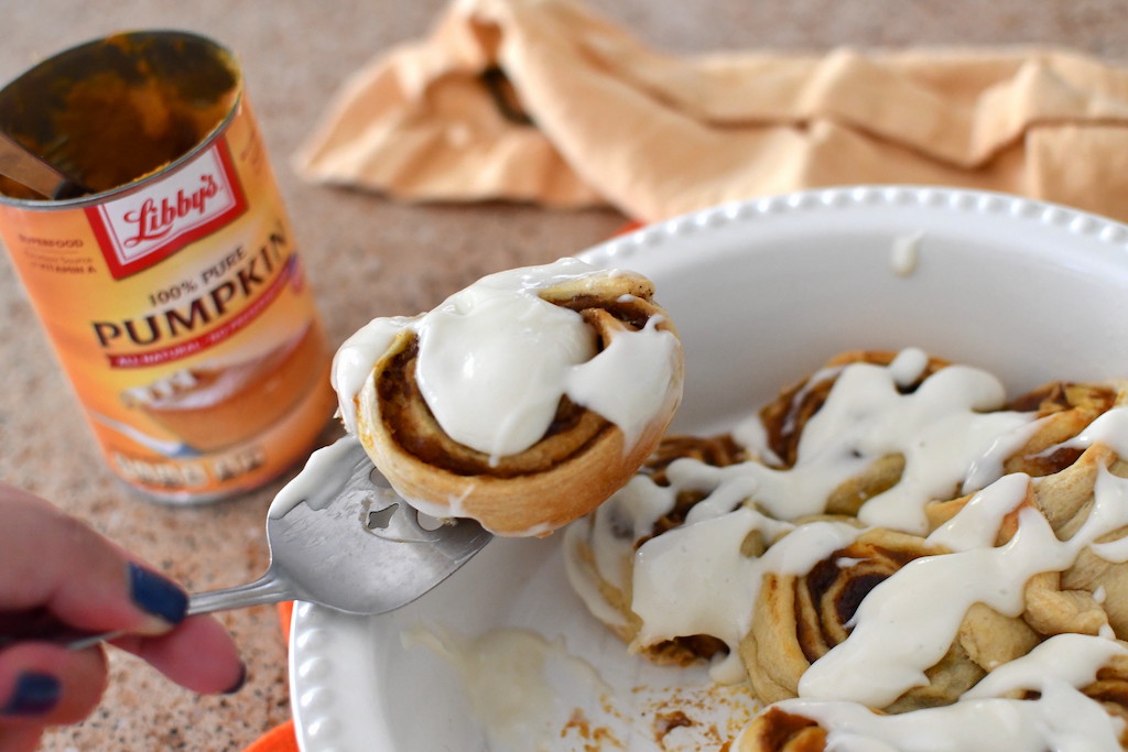 serving pumpkin cinnamon rolls with frosting 