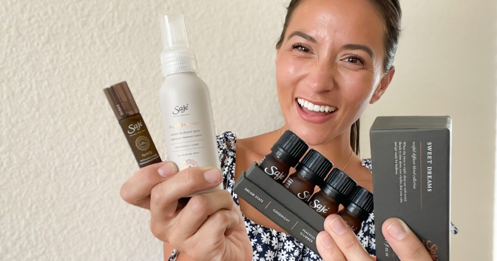 woman holding saje wellness products