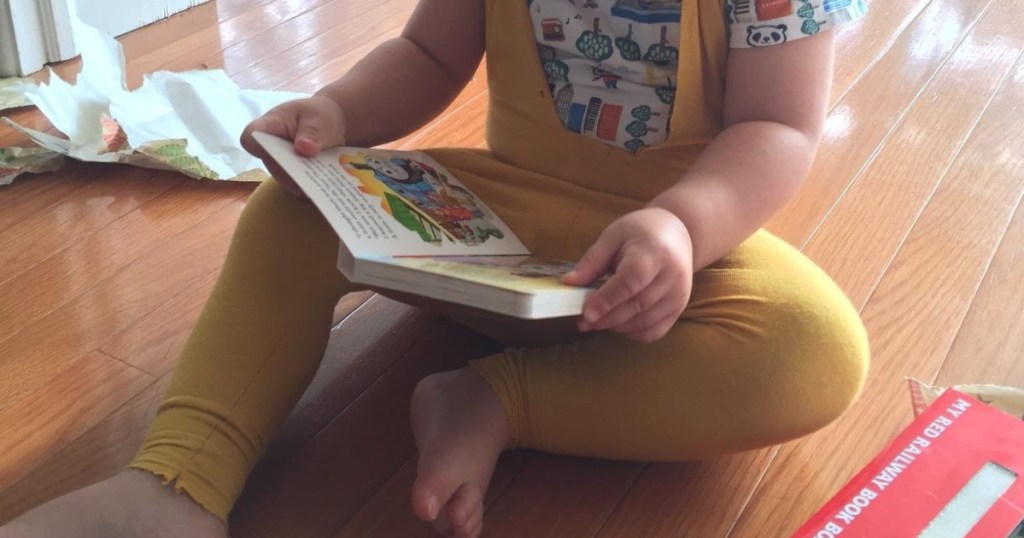 toddler holding a book