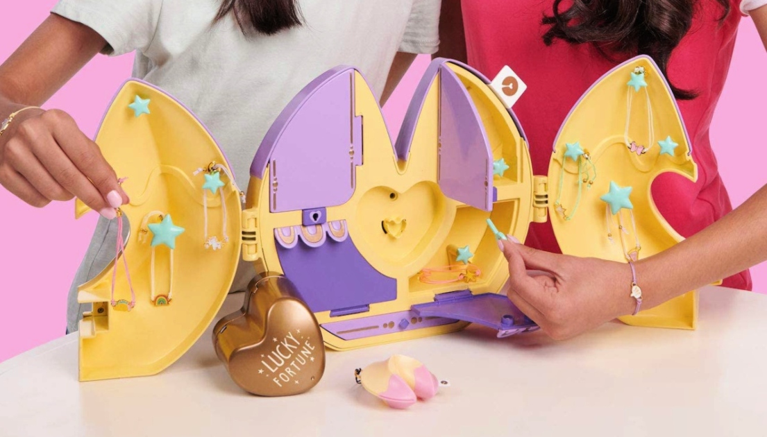 two girls playing with Wowwee playset at a table