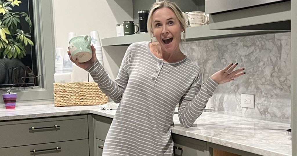 woman standing in the kitchen holding a coffee mug