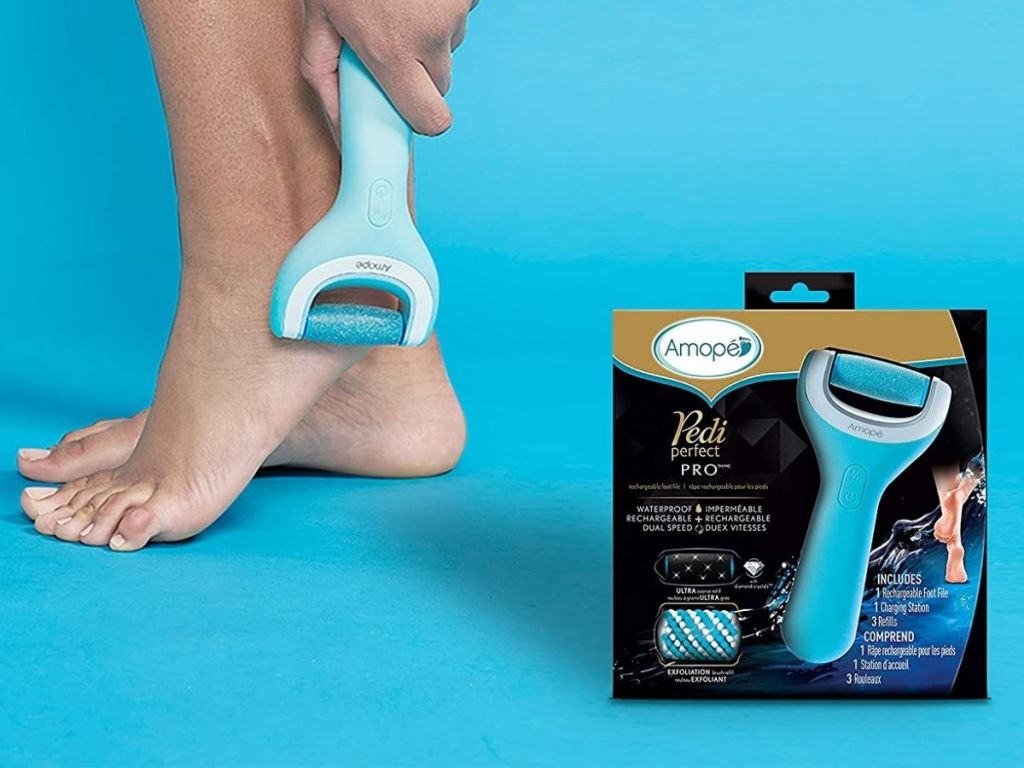 woman using Pedi Perfect on foot with Amope Pedi Perfect Pro box next to her