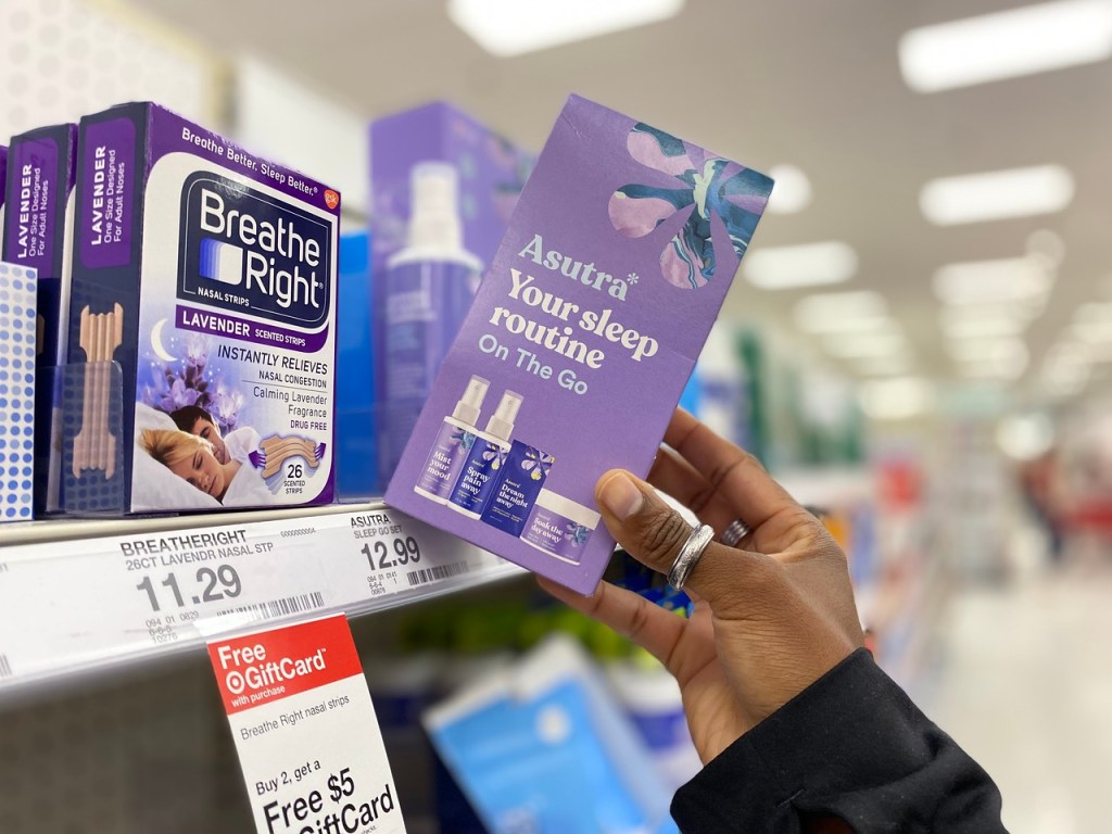 woman pulling a box of Asutra Sleep Routine from shelf