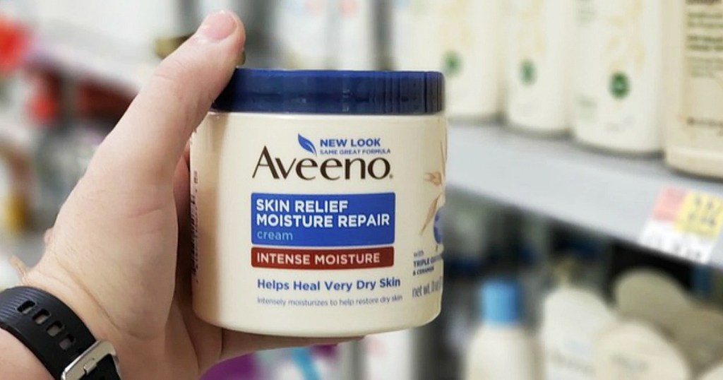 hand holding tub of moisturizing cream