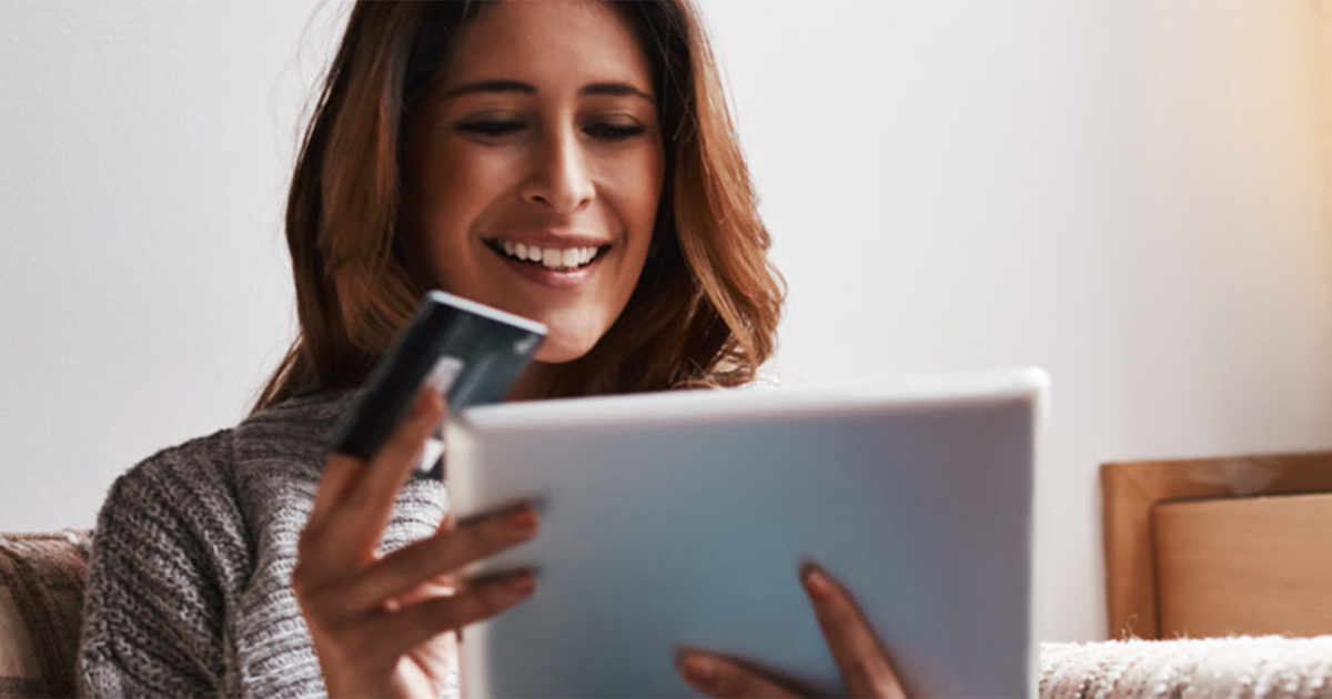 woman holding Capital One card