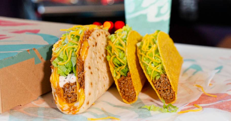 Cheesy Gordita Crunch next to 2 tacos at taco bell