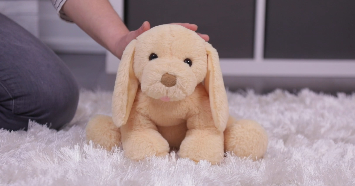 Plush puppy on white faux fur rug