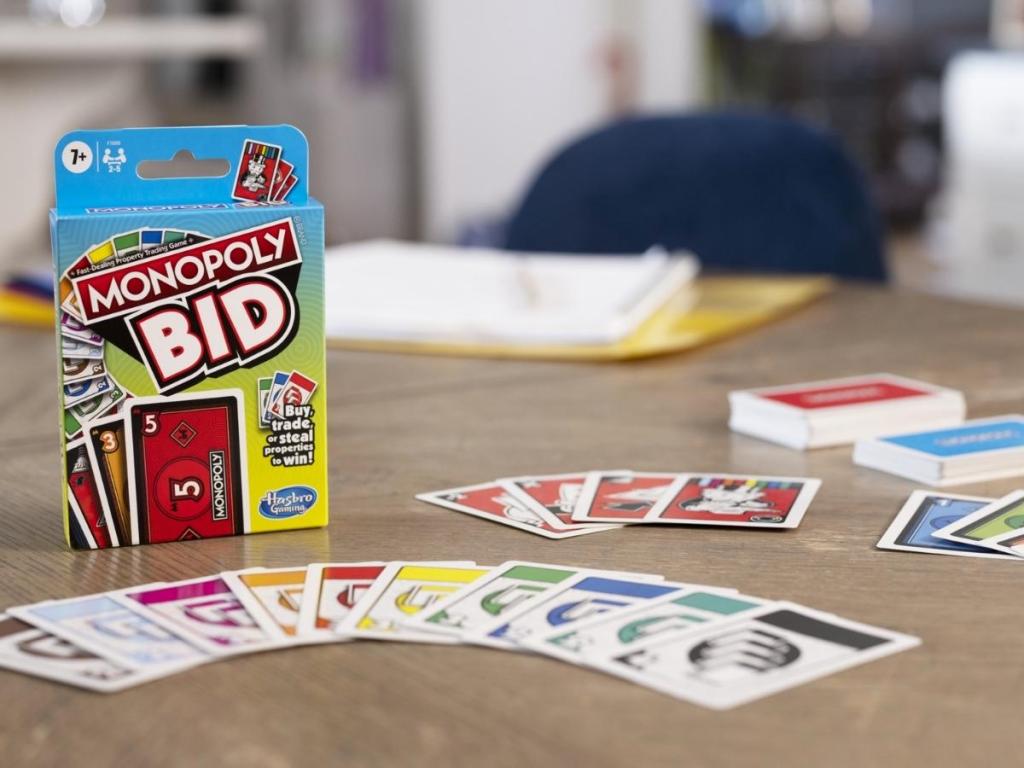 monopoly bid game with box and cards on table