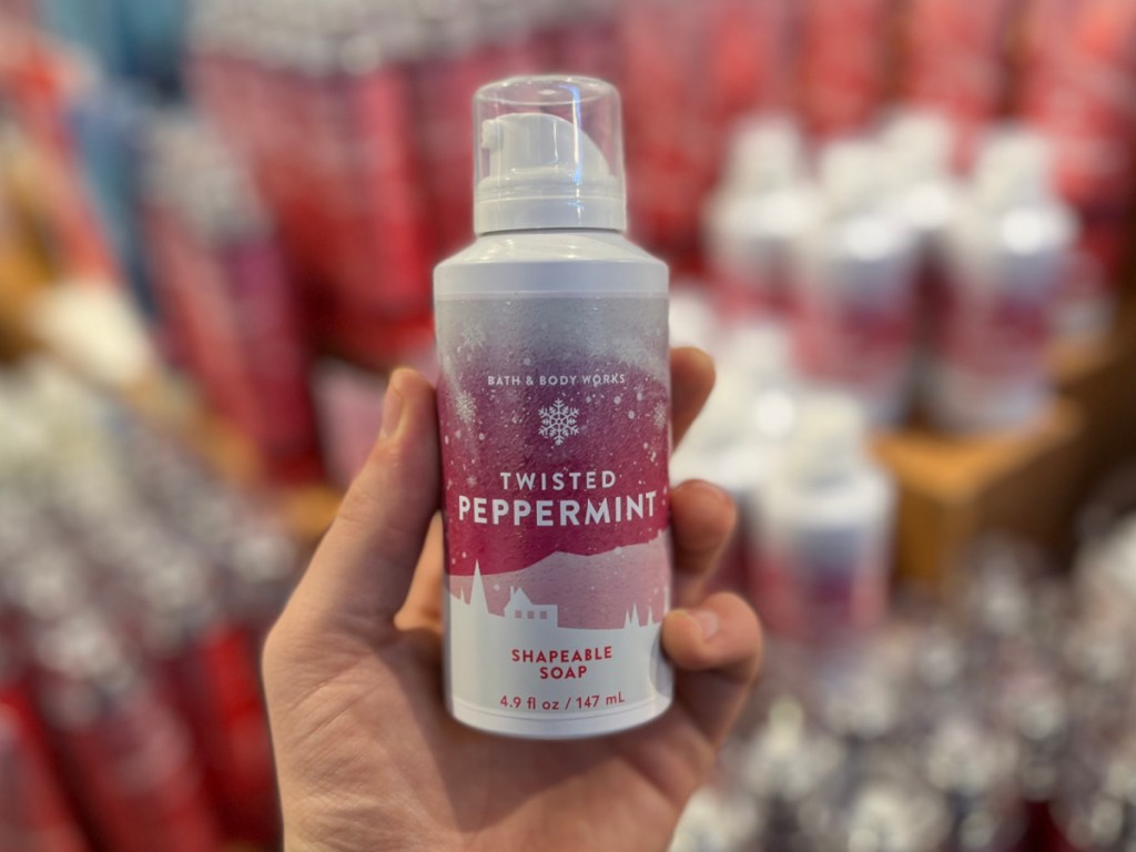 Person holding bottle of Twisted Peppermint Shapeable Soap