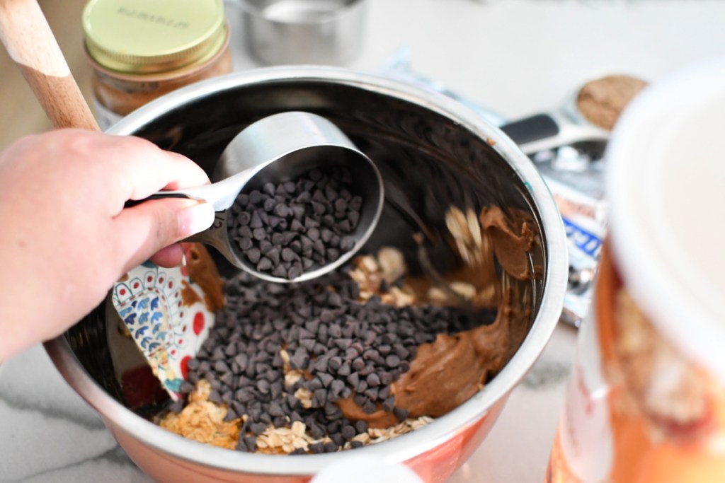 adding mini chocolate chips to bowl