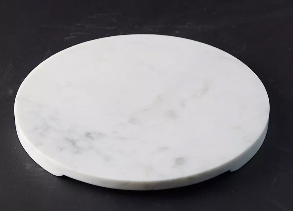 white marble tray on black background 