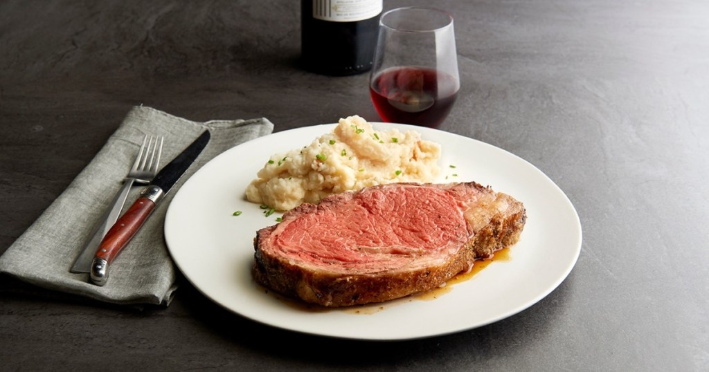 prime rib and mashed potatoes on white plate