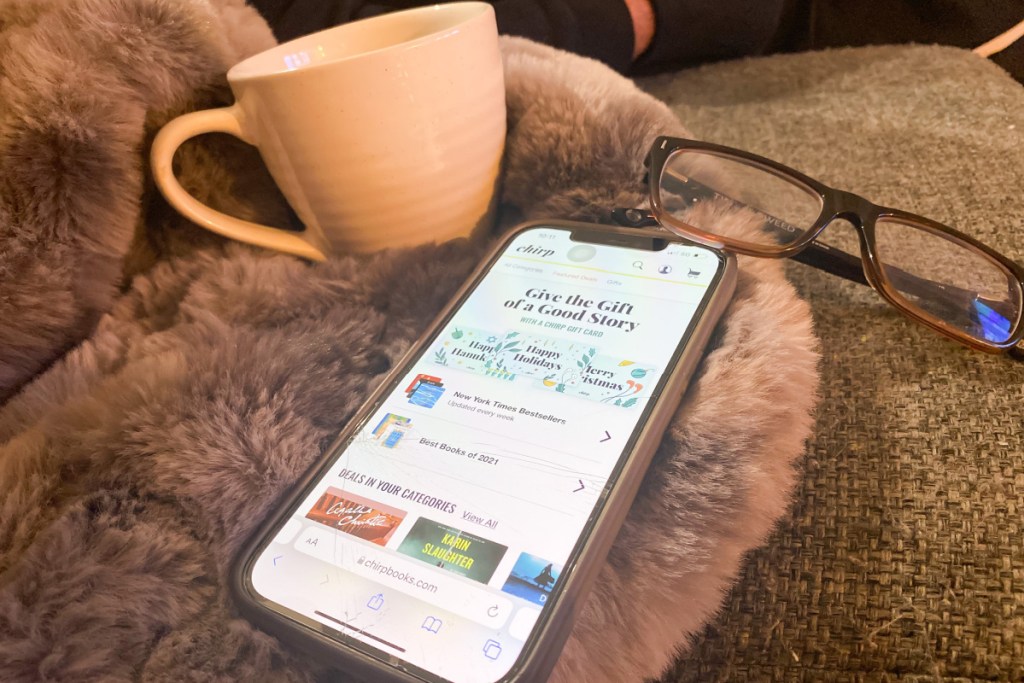 chirpbooks audiobooks on phone next to coffee mug