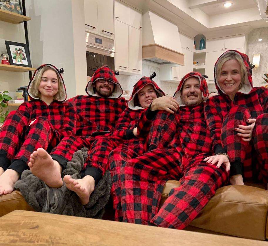 family wearing matching black and white christmas jammies