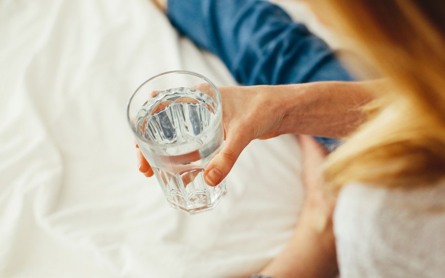 woman holding glass of water