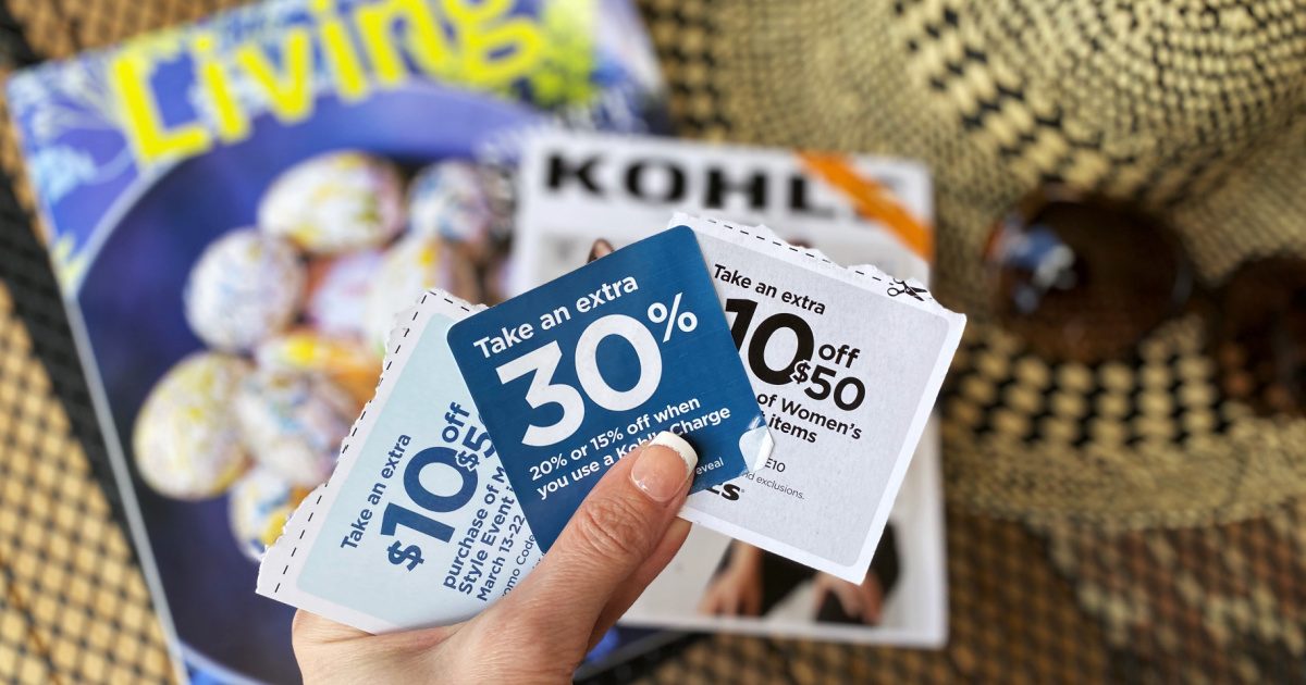 woman's hand full of coupons