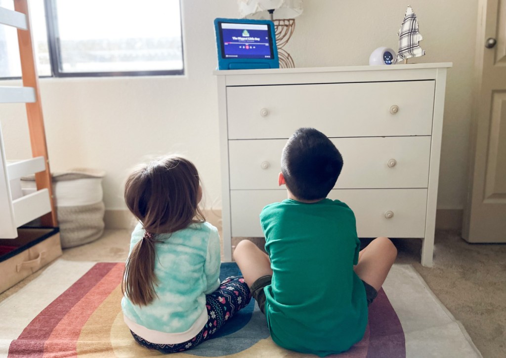 kids sitting around ipad listening to audiobook