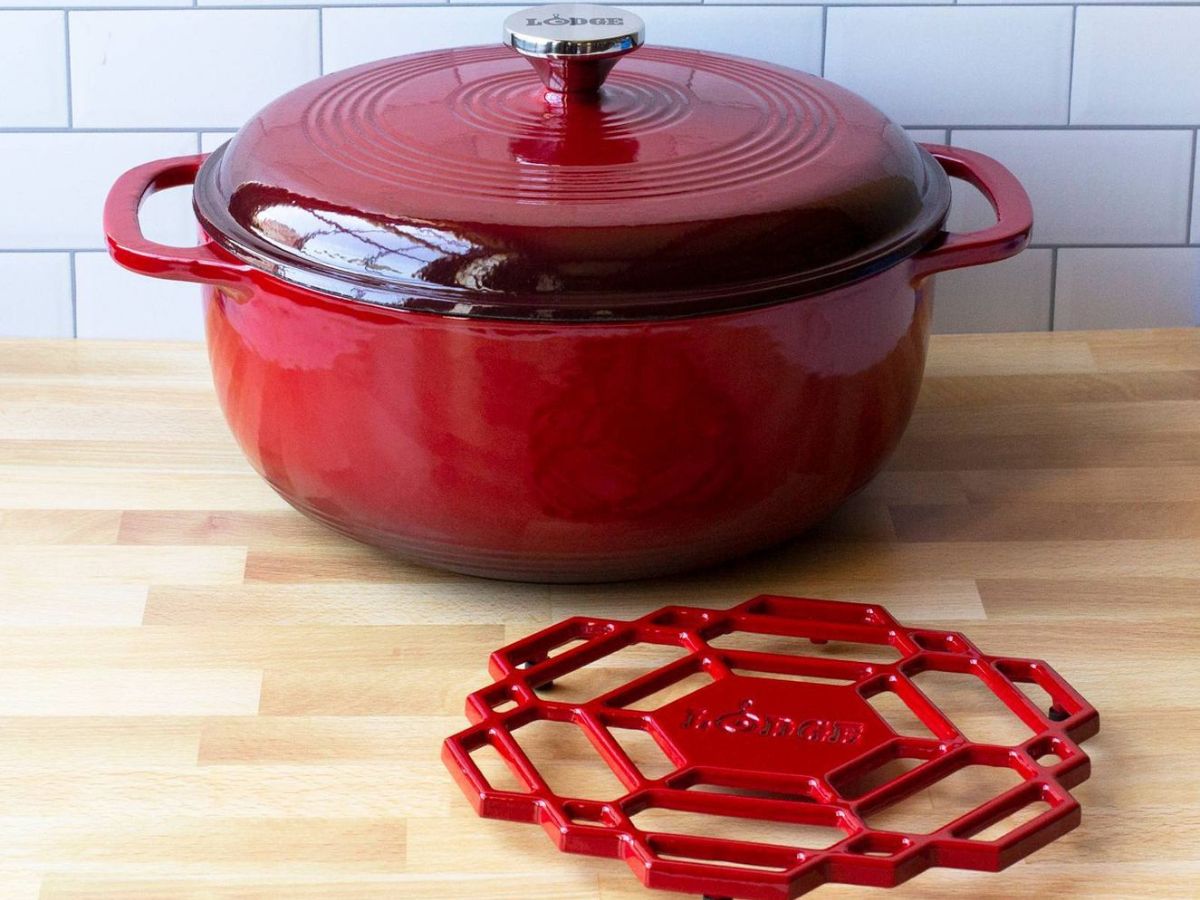 red dutch oven sitting beside matching trivet