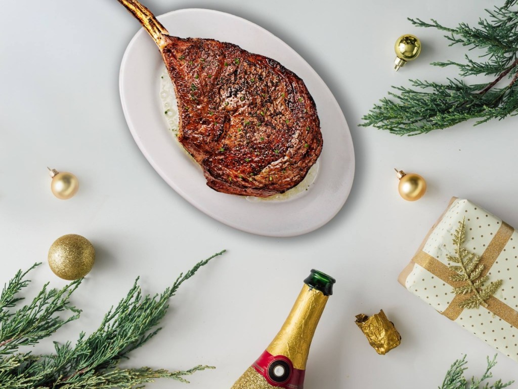 steak and champagne on table