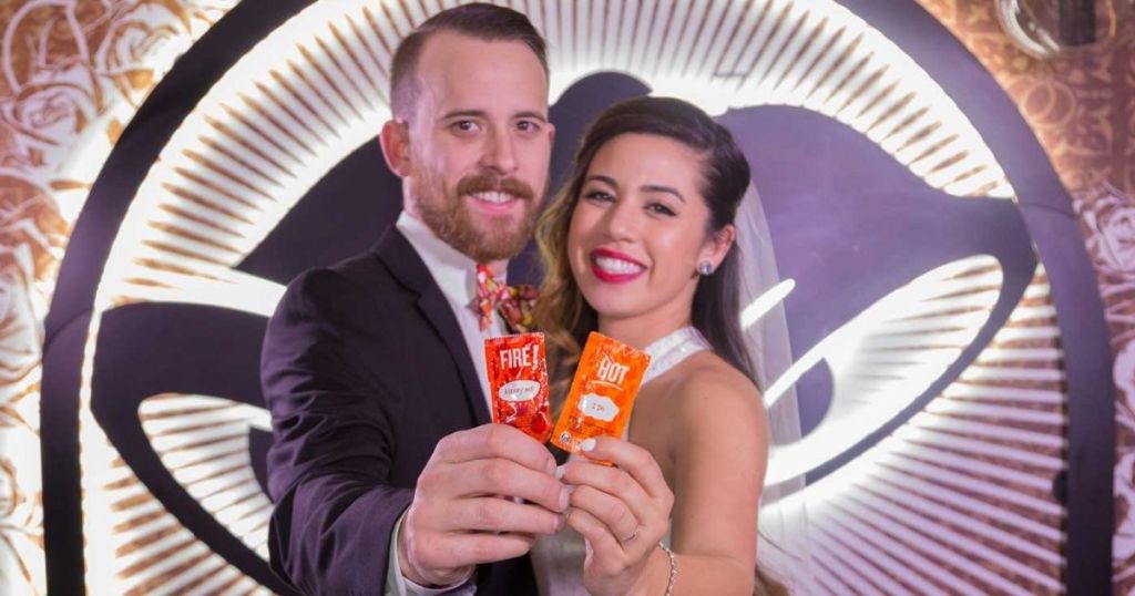 married couple holding Taco Bell sauce packets