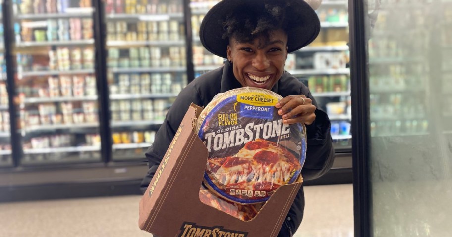 woman holding a frozen pizza