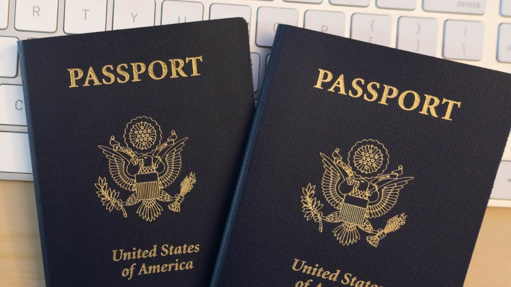 two passports on computer keyboard