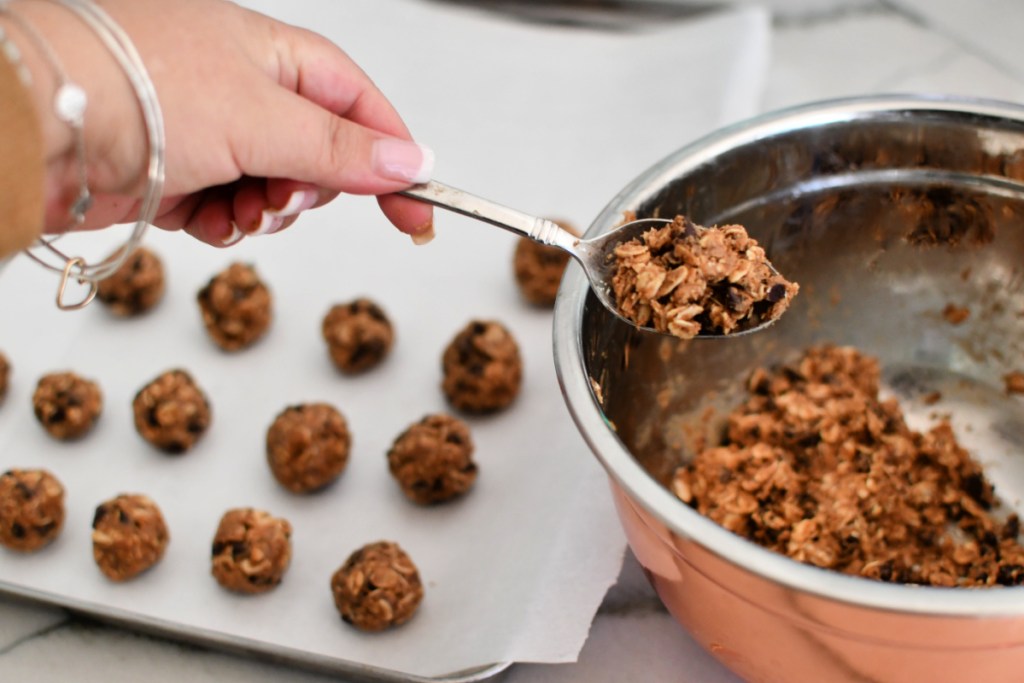 using a teaspoon to roll energy bites