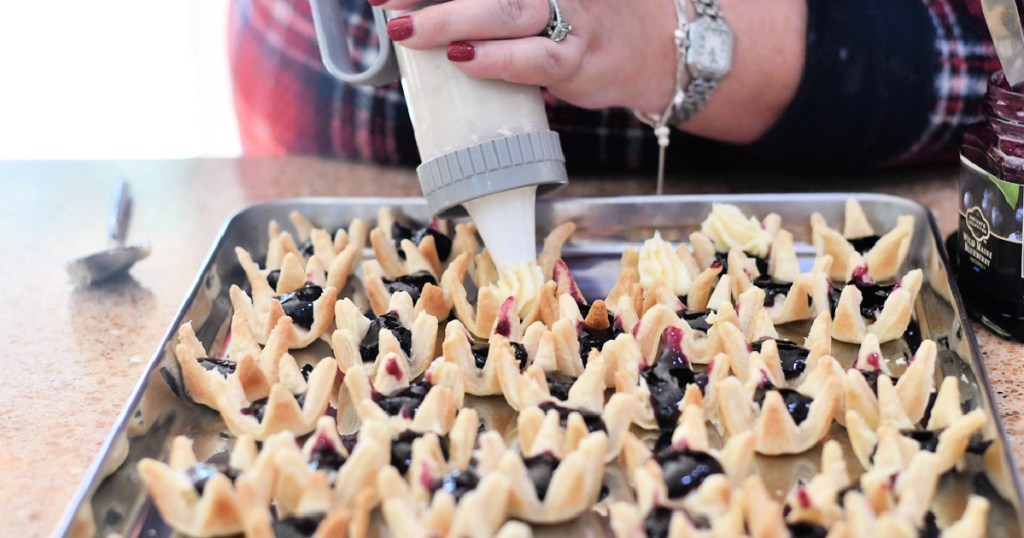 woman making blackberry cream cheese mini tarts