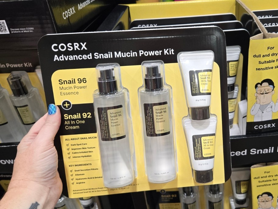 hand holding a COSRX Advanced Snail Mucin Power Kit with 5 different products in it at Costco